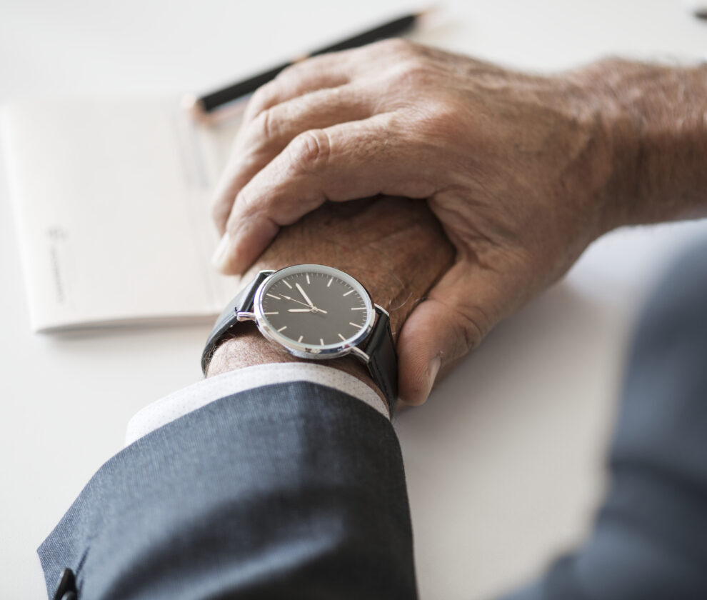 Businessman checking time on hand watch