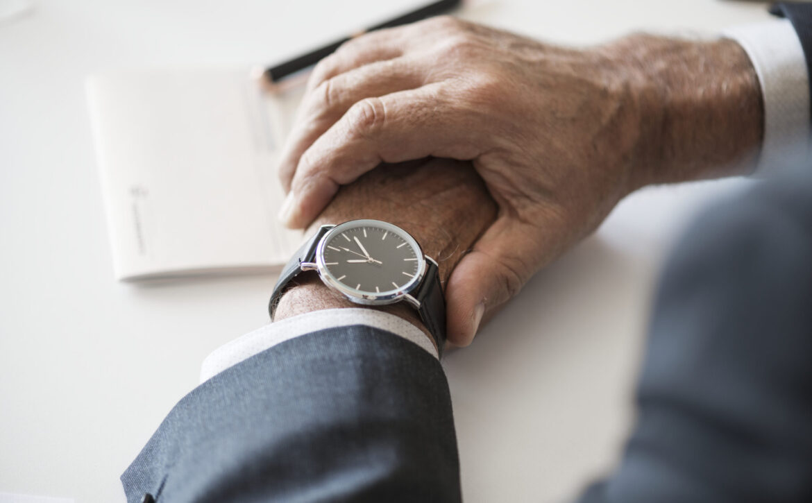 Businessman checking time on hand watch